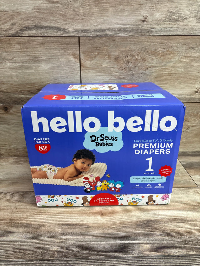 Front view of Hello Bello Premium Diapers size 1 box showcasing 82 diapers and Dr Seuss Babies design on a wood background