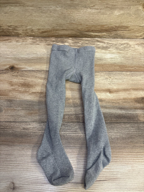Flat lay of Stelle ribbed footed dance tights in Grey, size 2T, showcasing ribbed texture and enclosed feet on a wood grain background