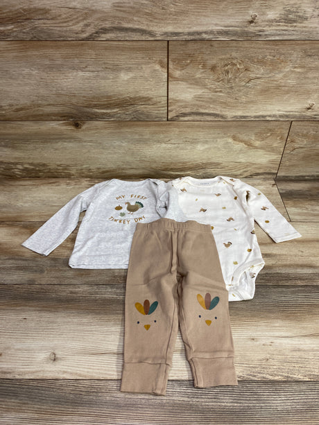 Flat lay of Just One You three piece Thanksgiving set showing a gray turkey shirt, white printed bodysuit, and tan pants