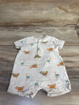 Front flat-lay of ivory baby henley shortie romper showcasing orange and teal car print, front henley button placket and snap crotch on wood background