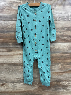 Teal baby romper with black polka dots and wood buttons on wooden background