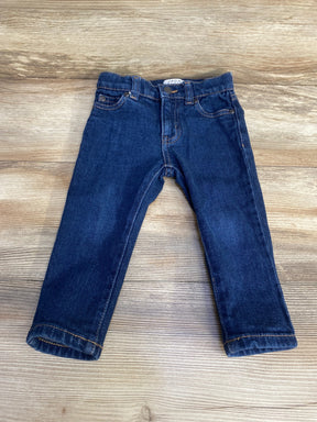 Front view of Jack toddler blue slim denim jeans showcasing five-pocket styling and rolled cuffs on a wood background
