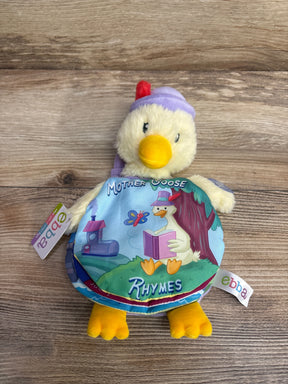 Front view of ebba Mother Goose plush book showing yellow duck with purple hat and fabric book labeled Mother Goose Rhymes on wood surface