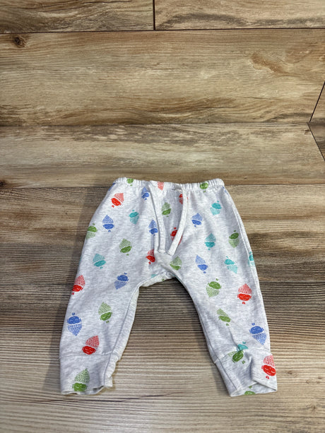Front flat-lay of grey baby harem pants (3-6M) with elastic waist, cuffed ankles and acorn print on wood
