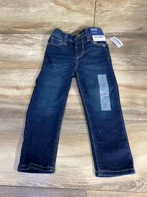 Flat lay of new Old Navy 360 Stretch skinny jeans in dark wash size 2T with hangtags on wood plank floor