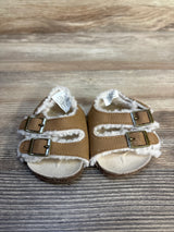 Front view of Old Navy sherpa-lined baby sandals size 1/2C showing double buckle straps on wood