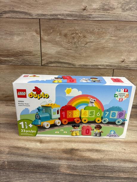 Front view of LEGO DUPLO Number Train toy box showcasing colorful numbered train cars and two figures on a wood surface