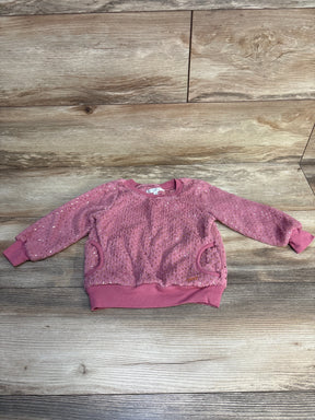 Pink toddler sweater with textured knit, long sleeves, and sequin details on wooden floor