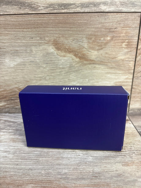 Side view of NEW Nanit Breathing Band sz 0-3m in sealed deep purple Nanit retail box on wood plank floor