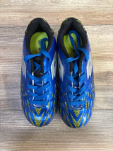 Top-down view of Lotto Forza II Jr soccer cleats in blue showing patterned yellow-green toe, white side logos, and lace-up closure on wood floor