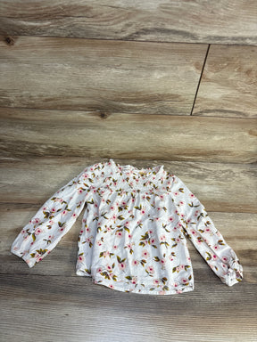 White floral long sleeve baby top with smocked neckline, perfect for kids' spring outfits