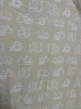 Top view of Tiny Adventures round baby playmat showing reversible tan fabric with white construction vehicle print, 36 x 36 in