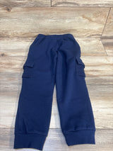Navy blue kids cargo joggers with elastic waist and side pockets, laid on wood floor