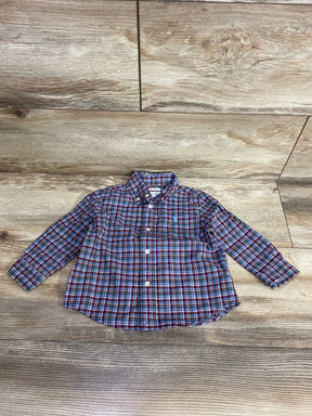 Red and blue plaid long sleeve button-up shirt for toddlers on wooden background