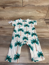 Top-down view of white Grayson Mini ribbed baby jumpsuit size 6-9 months showing teal palm tree print on wood background