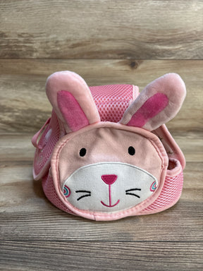Pink toddler backpack with cute bunny face and ears, kids accessory on wood background