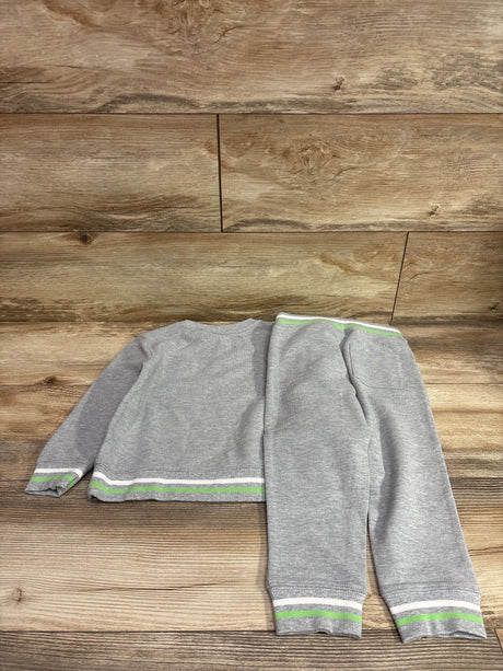 Overhead view of Janie and Jack 2 piece gray sweatshirt and pants set showcasing striped trim on a wood background