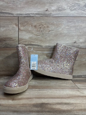 Kids glitter ankle boots with multicolor sparkles and rubber soles on wood background