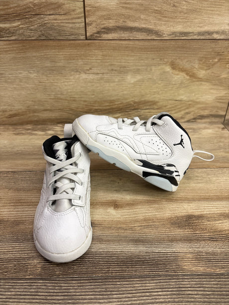 Front and side views of Jordan Jumpman MVP white and black sneakers showcasing Jumpman logos and textured panels on a wood floor