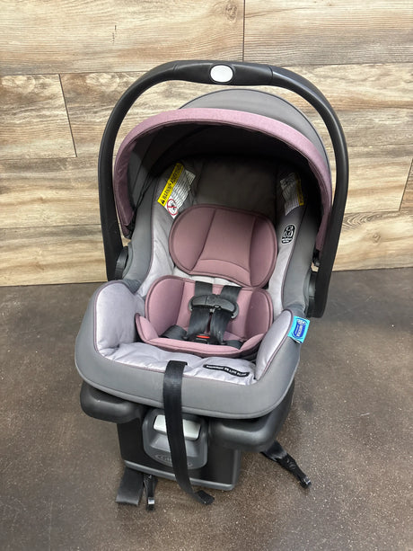 Front view of Graco SnugRide35 Infant Car Seat in Purple showcasing padded harness seat with wood-look floor background