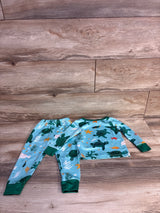 Flat lay of blue 2-piece sea turtle 2T pajamas showing long-sleeve top and elastic pants with green cuffs on wood floor