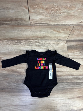 Black long-sleeve baby bodysuit with colorful text reading Family Time Is My Favorite, laid on wooden floor