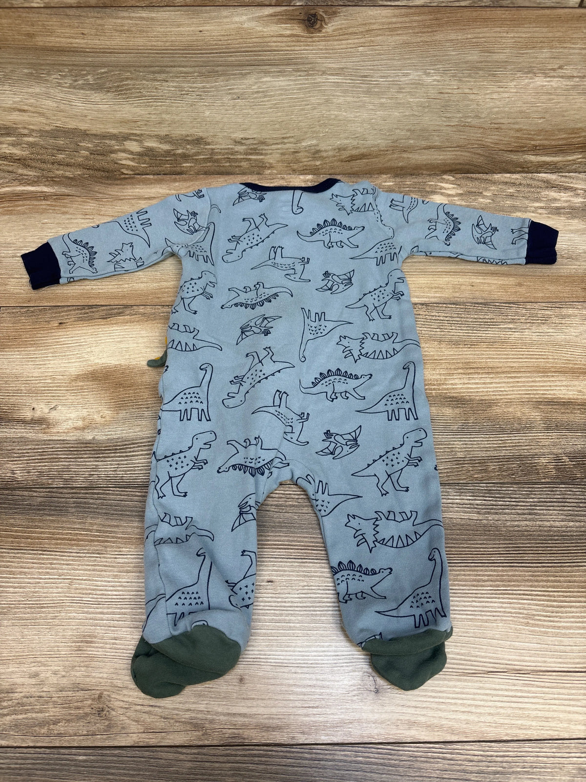 Overhead view of blue Koala Baby Dino Sleeper showcasing dinosaur print, long sleeves, and enclosed feet on wood background