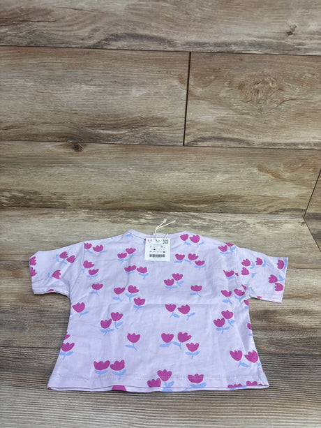 Front view of a lilac Zara tulip shirt in size 2T showcasing short sleeves and tulip print on a wood-look background