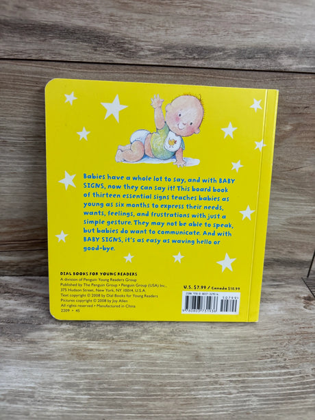 Back cover of Baby Signs board book showcasing thirteen essential baby signs with a yellow starry cover on a wood surface