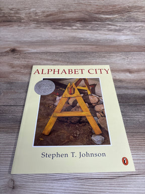 Cover of Alphabet City book by Stephen T. Johnson featuring wooden A-frame and rocks illustration