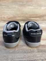 Black Stride Rite 360 toddler shoes with gray lining on wooden surface, rear view