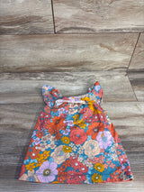 Flat-lay front of girls' blue floral tank top size 2T with ruffle straps on wood background