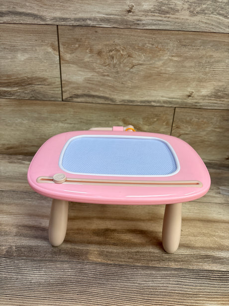 Front view of pink Kikidex toddler magnetic drawing board showcasing blue drawing screen and attached stylus with wood background