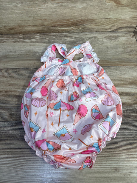 Flat lay of pink crossback baby romper (12-18M) with seashell and ice cream print, crisscross straps on wood