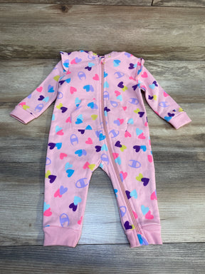 Pink baby sleeper with colorful heart print and zipper, laid flat on wooden floor