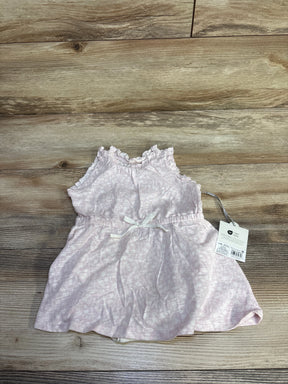 Top-down view of Cloud Island pink 2-piece baby tank dress with matching bloomers, ruffled shoulders and waist bow on light wood background