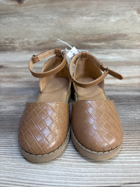 Brown woven faux leather girls' closed-toe sandals with ankle straps on wooden background