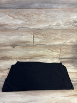 Black maternity or kids clothing item on wooden floor, ideal for resale shopping
