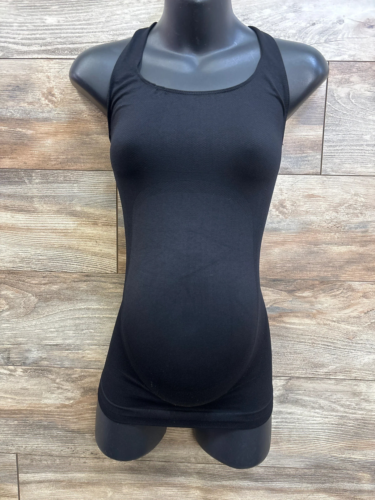 Front view of Blanqi maternity crossback sport tank, black, on mannequin showing built-in belly support and seamless fit