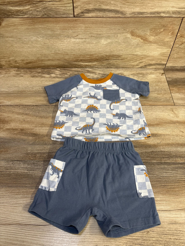 Flat lay of blue 2-piece dinosaur shirt and shorts showing checkerboard dino print, chest pocket and elastic waist on wood