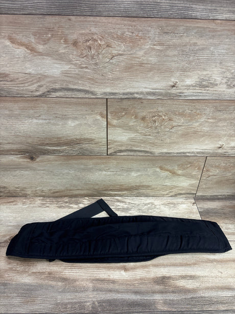 Top view of black Senerah sling carrier showcasing its padded panel and strap on a wood-look floor