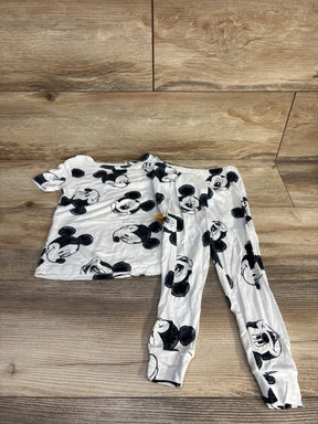 Flat lay of toddler white Disney Mickey 2-piece viscose pajama set showing black Mickey face print on wood floor