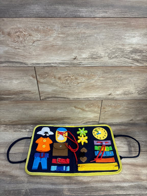 Front view of Hooku Montessori busy felt book open showing colorful interactive activities, zippers, buckles, laces and a play clock on wood background