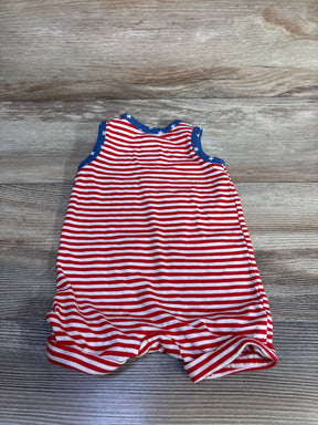 Flat-lay of newborn red-and-white striped sleeveless Henley shortie romper showcasing blue star-trim on a wood background