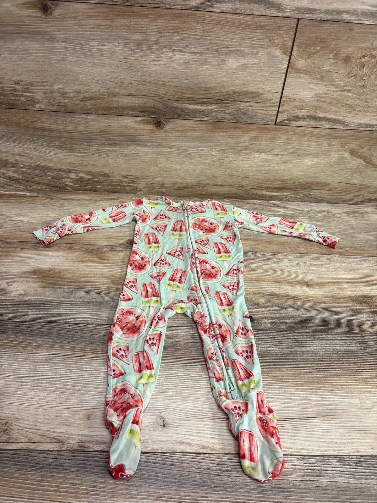 Front view of green LEV Baby Watermelon bamboo footie sleeper with zipper, long sleeves, covered feet, and watermelon pattern
