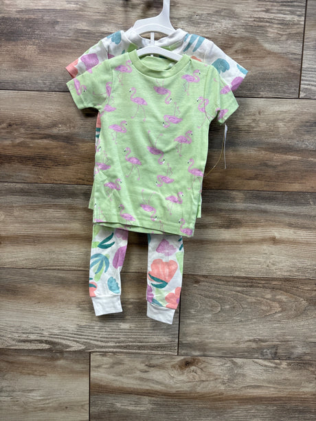 Front view of Just One You 4 piece baby pajama set with green flamingo top and white floral leggings on wooden floor