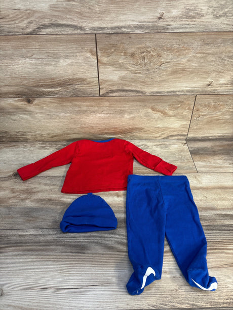 Infant outfit with red long-sleeve shirt, blue pants with footies, and matching blue hat