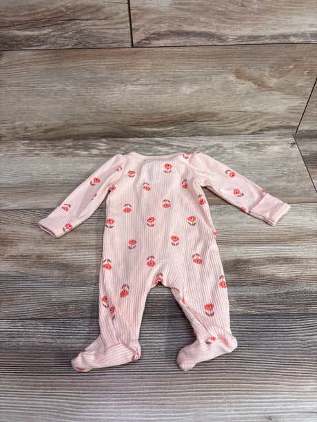 Front view of Carter’s ribbed sleeper in peach showcasing floral print, long sleeves, and footed legs on a wood-look floor