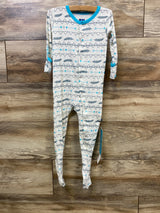 Baby sleeper with tribal arrow and feather pattern, blue trim, long sleeves, wood background