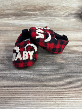 Red plaid baby booties with 'BABY BEAR' text on wooden background